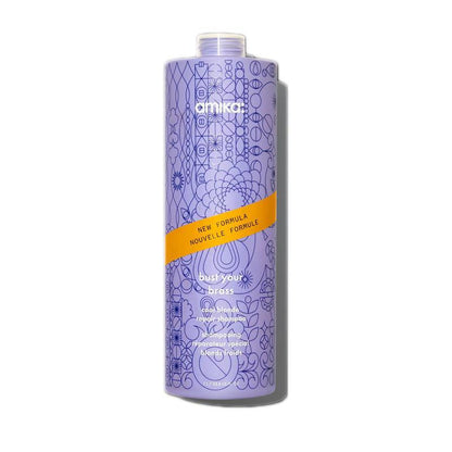 Amika Bust Your Brass Cool Blonde Repair Shampoo front bottle at Pasadena Aveda salon